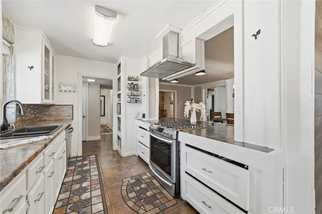 a kitchen with stainless steel appliances granite countertop a sink and cabinets