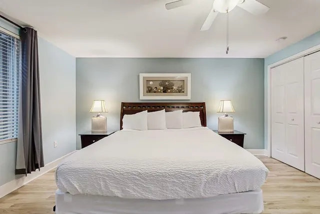 a bedroom with a bed and a painting