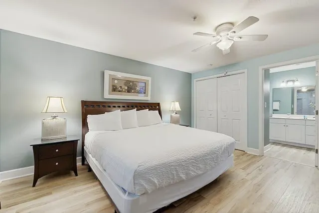 a bedroom with a large bed and a chandelier