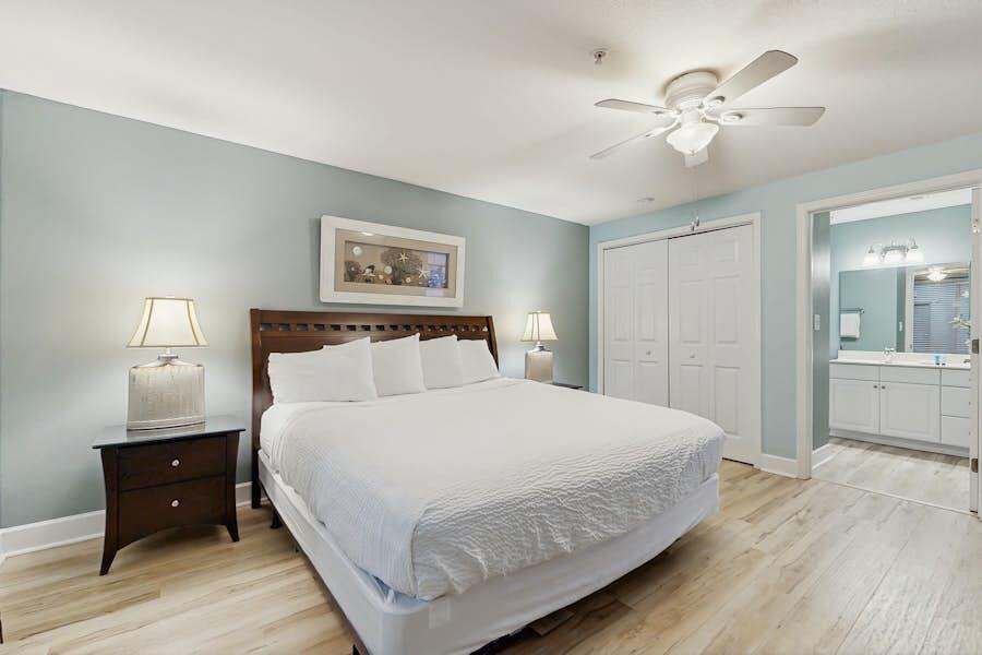 16819 Front Beach Road, Unit 602 Panama City Beach, FL 32413 - Photo 16 of 53 a bedroom with a large bed and a chandelier