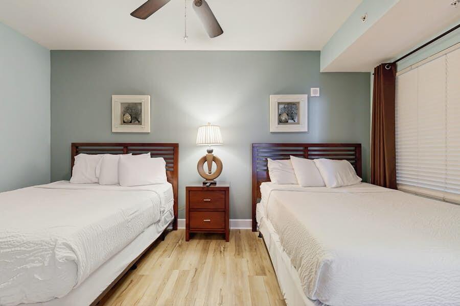 16819 Front Beach Road, Unit 602 Panama City Beach, FL 32413 - Photo 19 of 53 a bedroom with a bed and a night stand