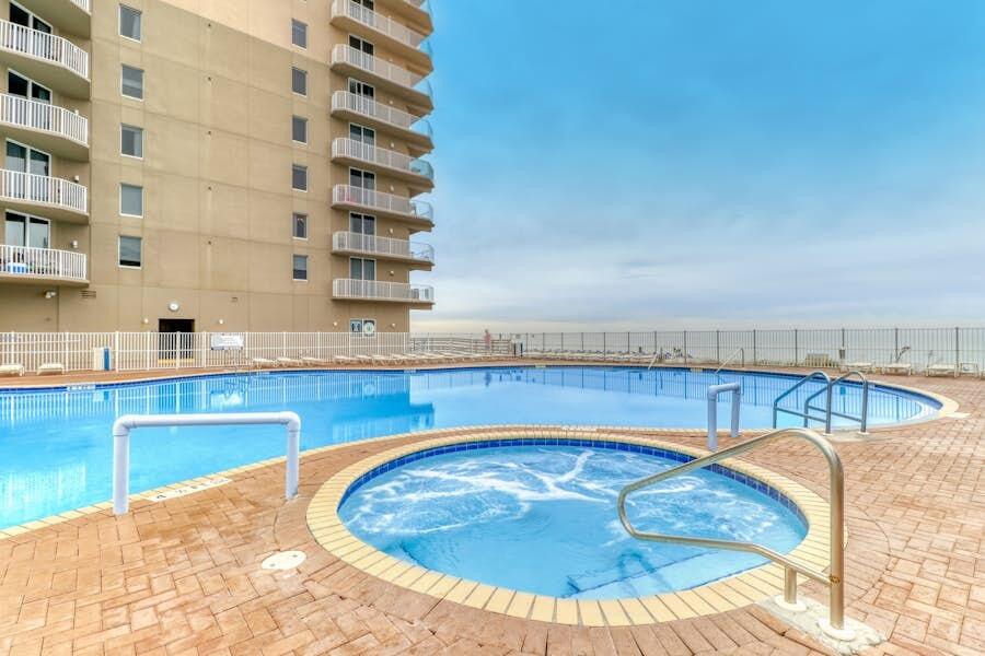 16819 Front Beach Road, Unit 602 Panama City Beach, FL 32413 - Photo 37 of 53 a view of a swimming pool with a lounge chair