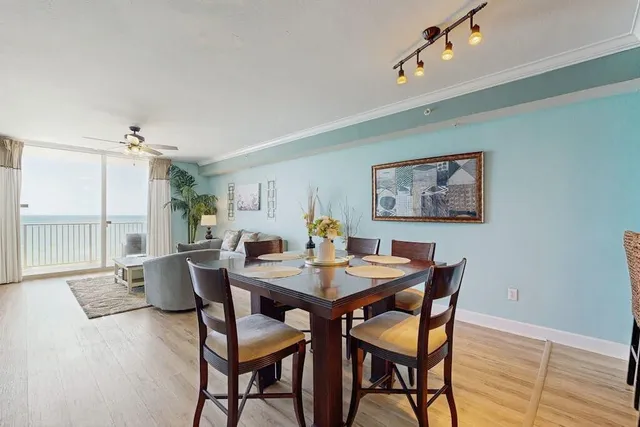 a view of a dining room with furniture large window and wooden floor