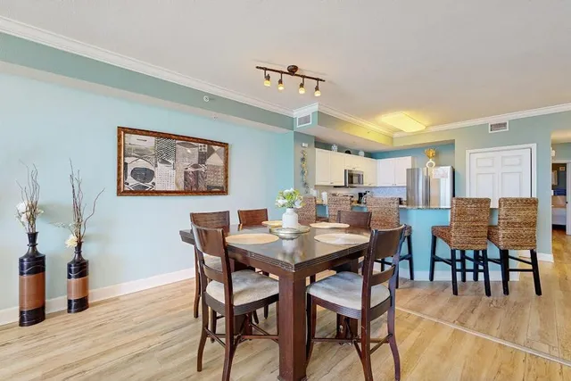 a view of a dining room with furniture and wooden floor