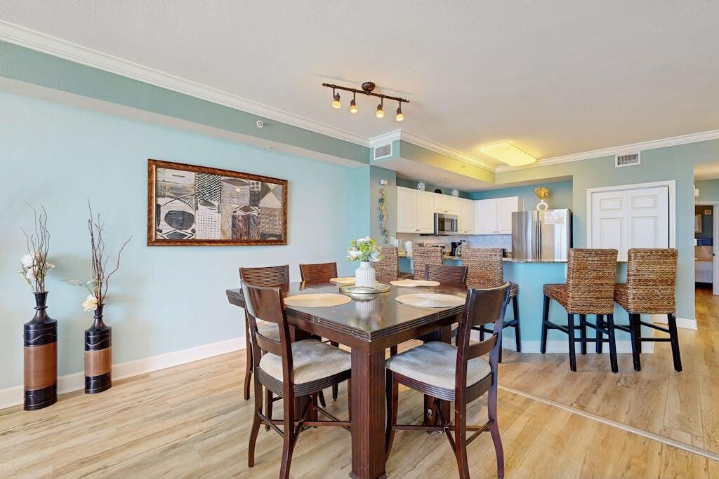 16819 Front Beach Road, Unit 602 Panama City Beach, FL 32413 - Photo 6 of 53 a view of a dining room with furniture and wooden floor