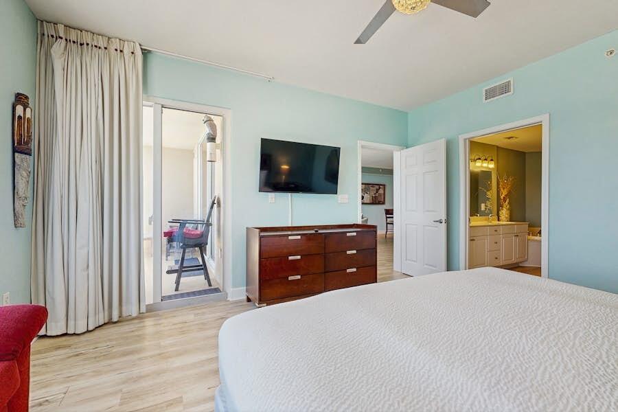 16819 Front Beach Road, Unit 602 Panama City Beach, FL 32413 - Photo 10 of 53 a bedroom with a bed and a flat screen tv