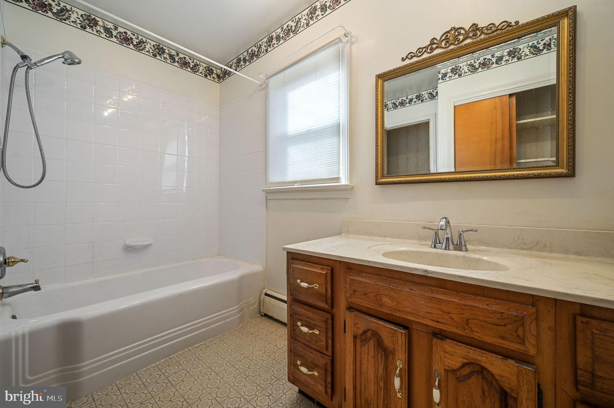55 Boyd Circle Dover, DE 19901 - Photo 20 of 24 a bathroom with a sink a vanity and a mirror