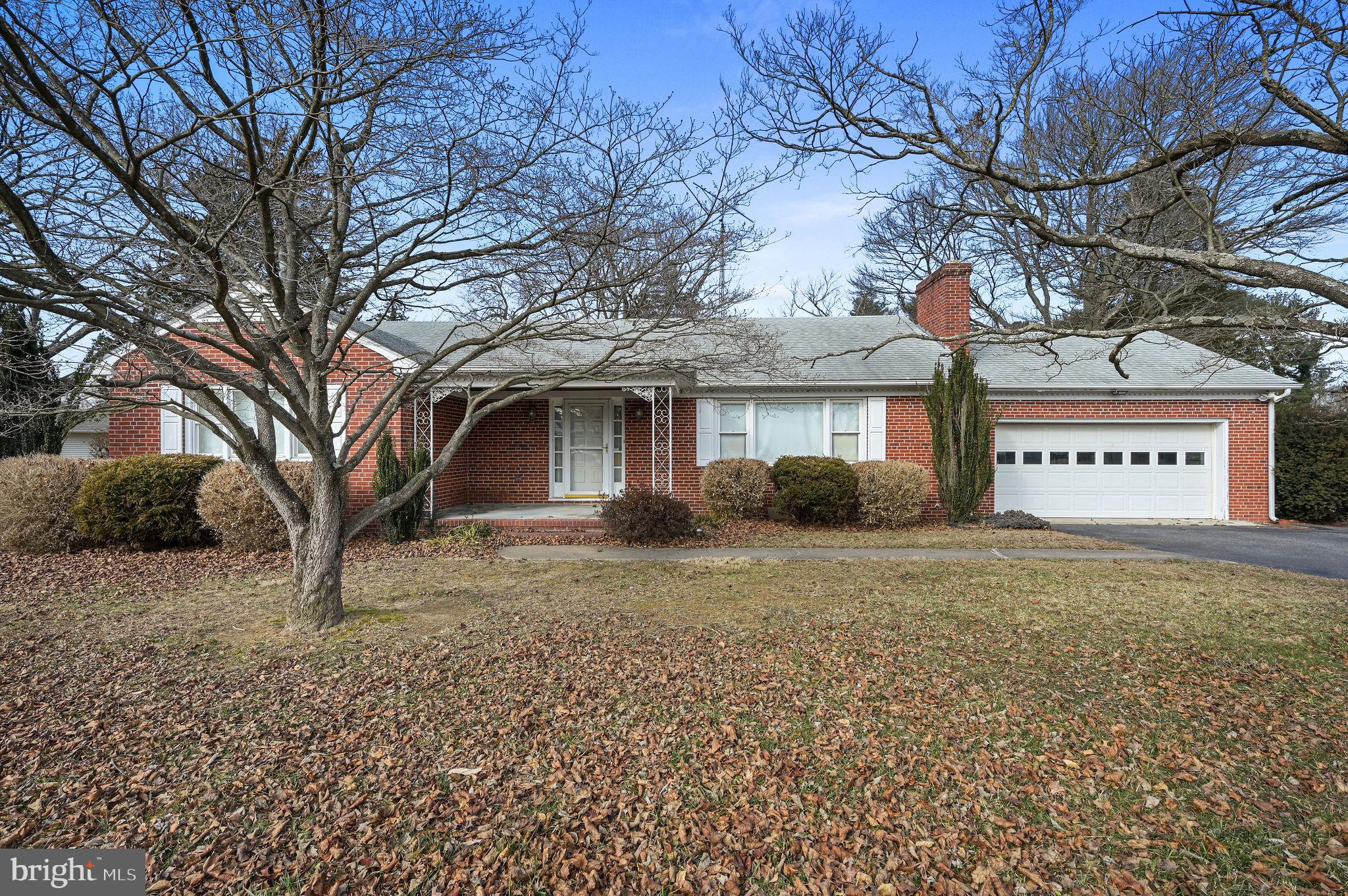 55 Boyd Circle Dover, DE 19901 - Photo 2 of 24 a front view of a house with a yard and garage