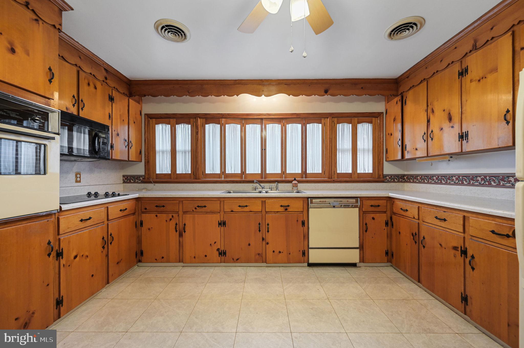 55 Boyd Circle Dover, DE 19901 - Photo 5 of 24 a large kitchen with granite countertop a sink and white cabinets