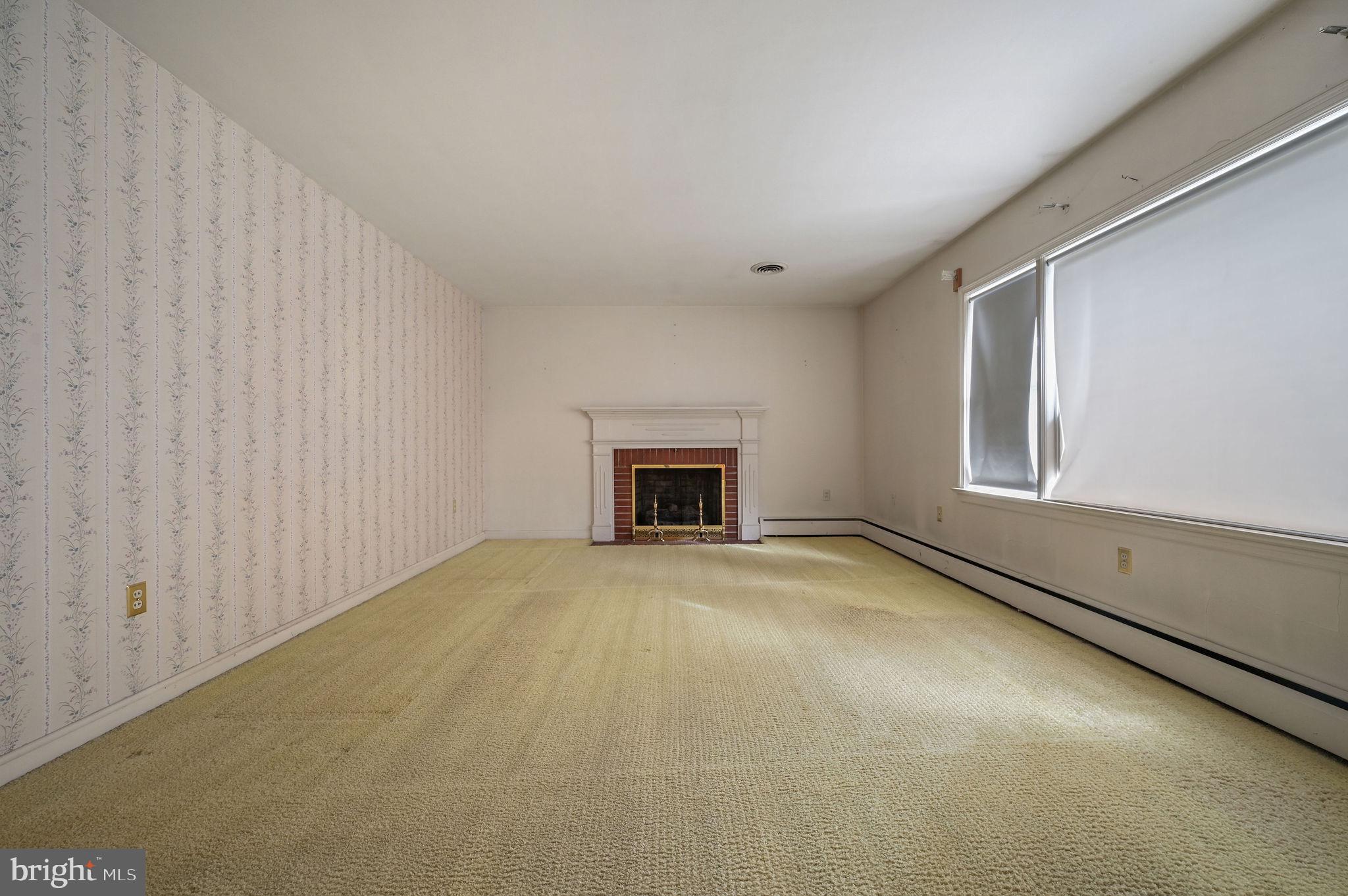 55 Boyd Circle Dover, DE 19901 - Photo 10 of 24 a view of an empty room with a fireplace and a window