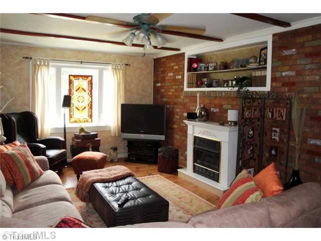 706 Rockspring Road High Point, NC 27262 - Photo 5 of 16 Den/Family/Great Room. Entering the home from the carport you come into this cozy den with gas log fireplace, exposed brick wall and warm wood laminate floors.