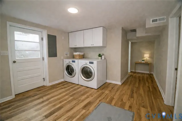 a view of a storage and utility room with washer and dryer