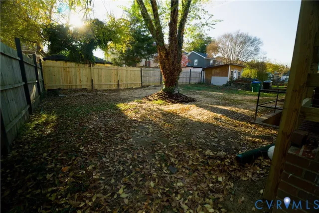 a view of a backyard with tree