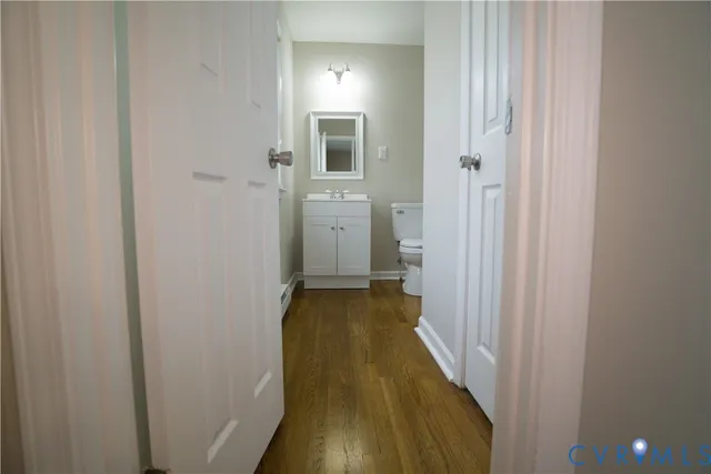 a view of a bathroom with sink and wooden floor