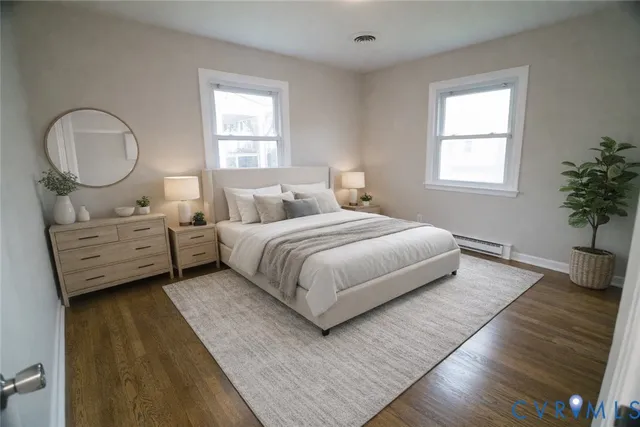 a bedroom with a bed mirror and window