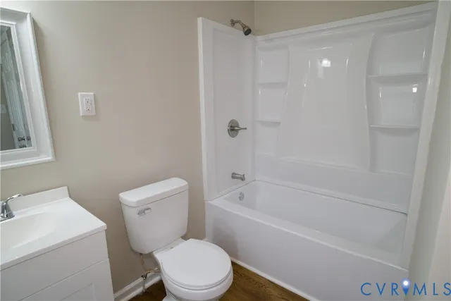 a white toilet sitting next to a bath tub