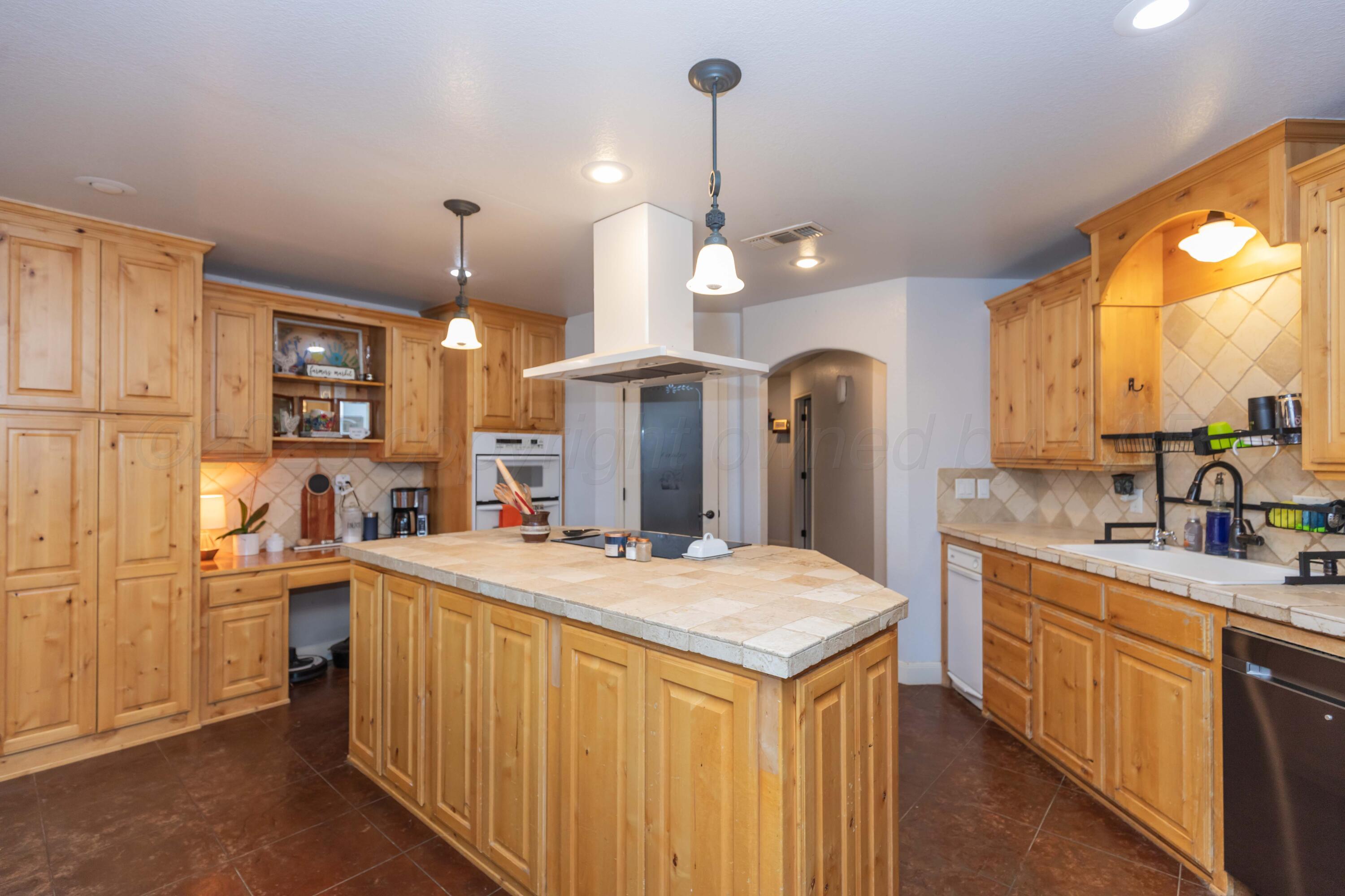 1301 Moon Ridge Lane Amarillo, TX 79124 - Photo 12 of 34 a kitchen with a sink a counter space appliances and cabinets