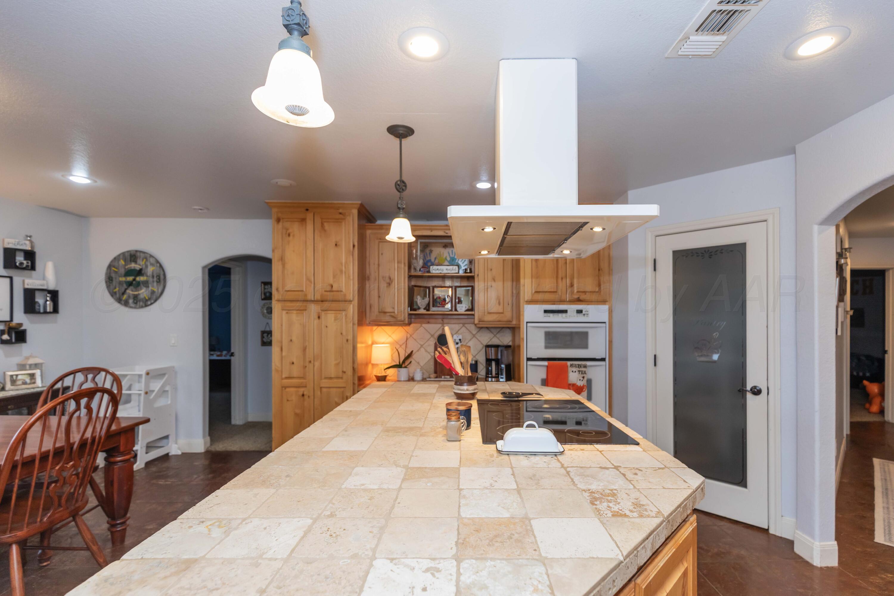 1301 Moon Ridge Lane Amarillo, TX 79124 - Photo 13 of 34 a living room with stainless steel appliances kitchen island granite countertop furniture and a chandelier