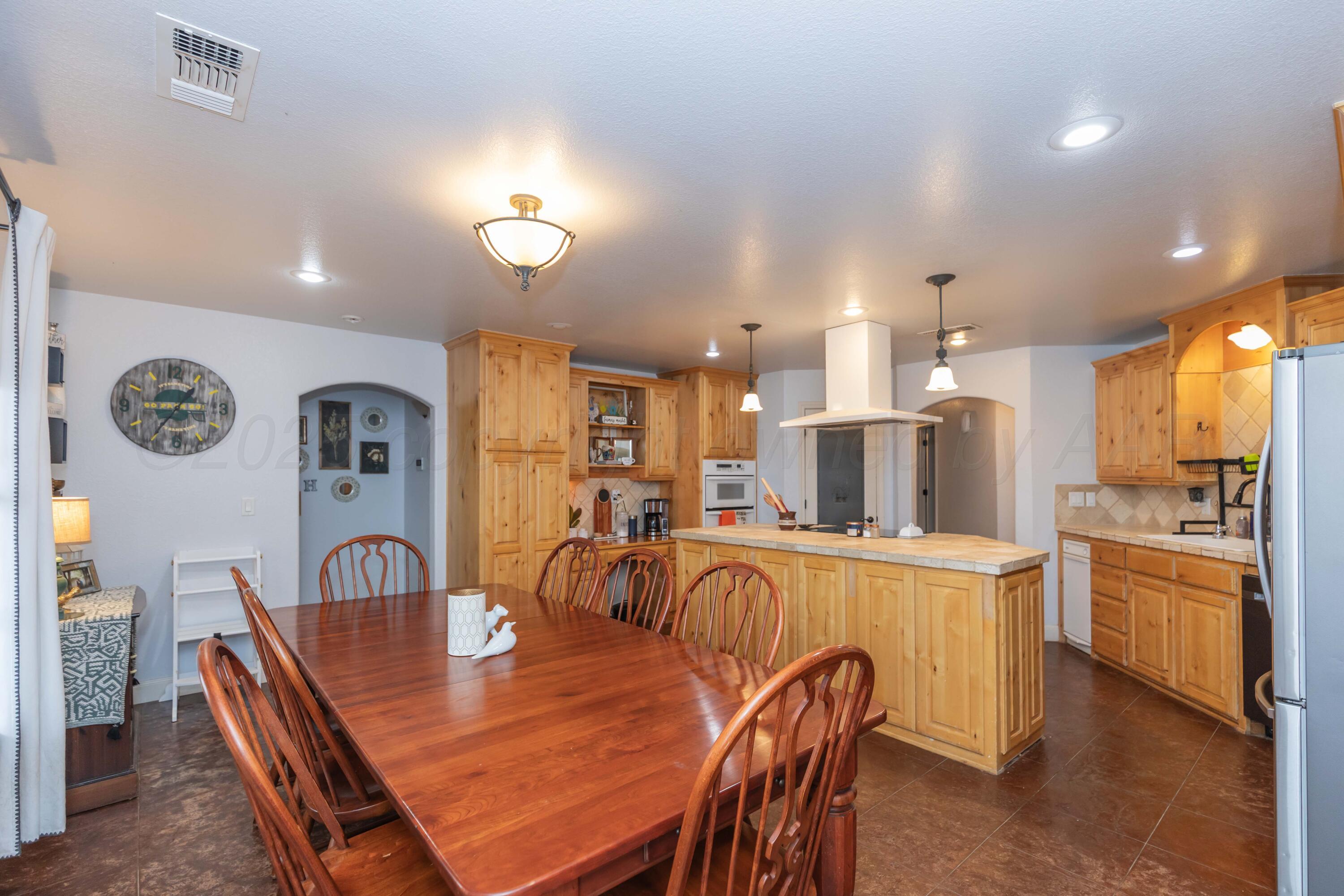 1301 Moon Ridge Lane Amarillo, TX 79124 - Photo 16 of 34 a large kitchen with a table and chairs