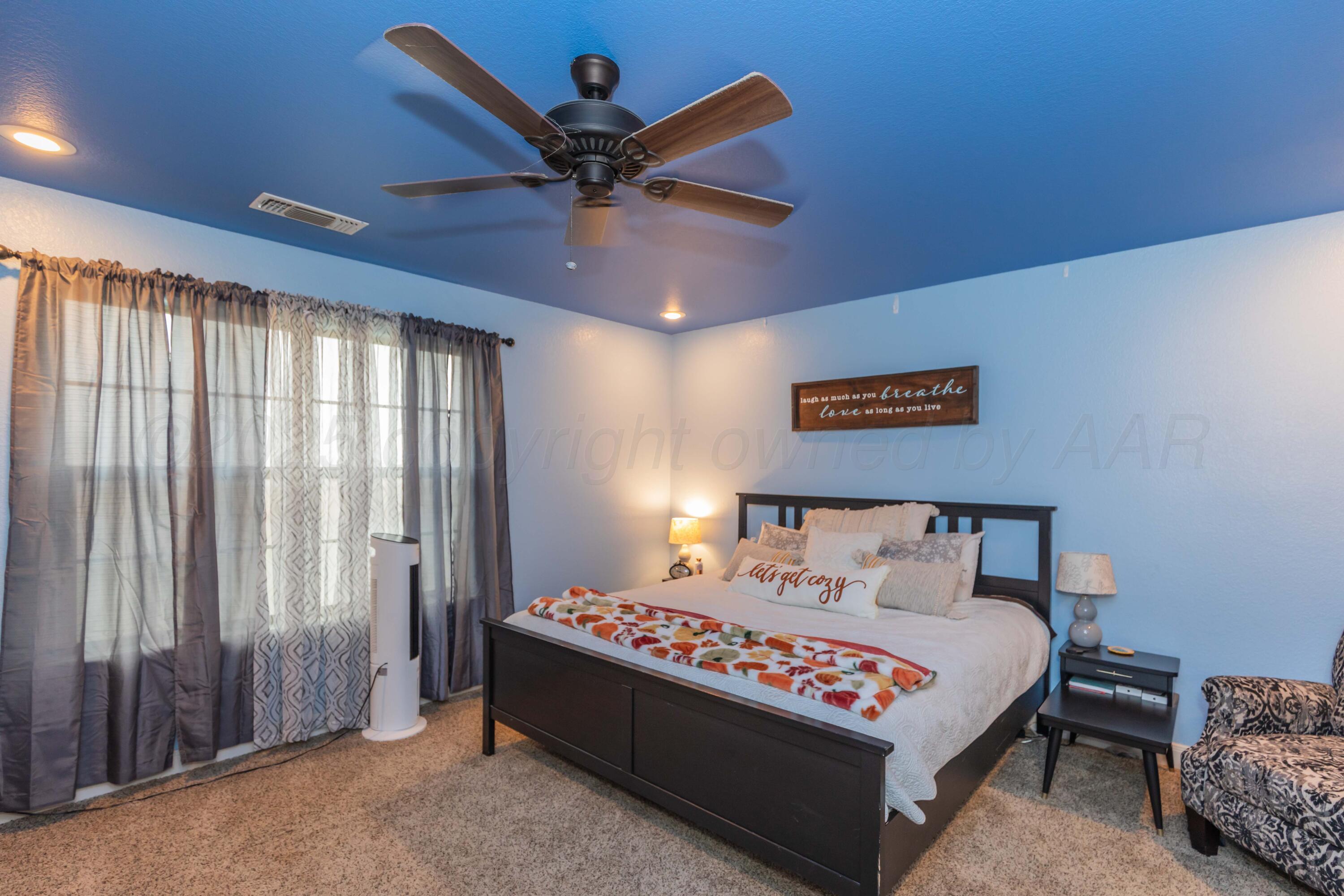 1301 Moon Ridge Lane Amarillo, TX 79124 - Photo 18 of 34 a bed room with a bed and a ceiling fan
