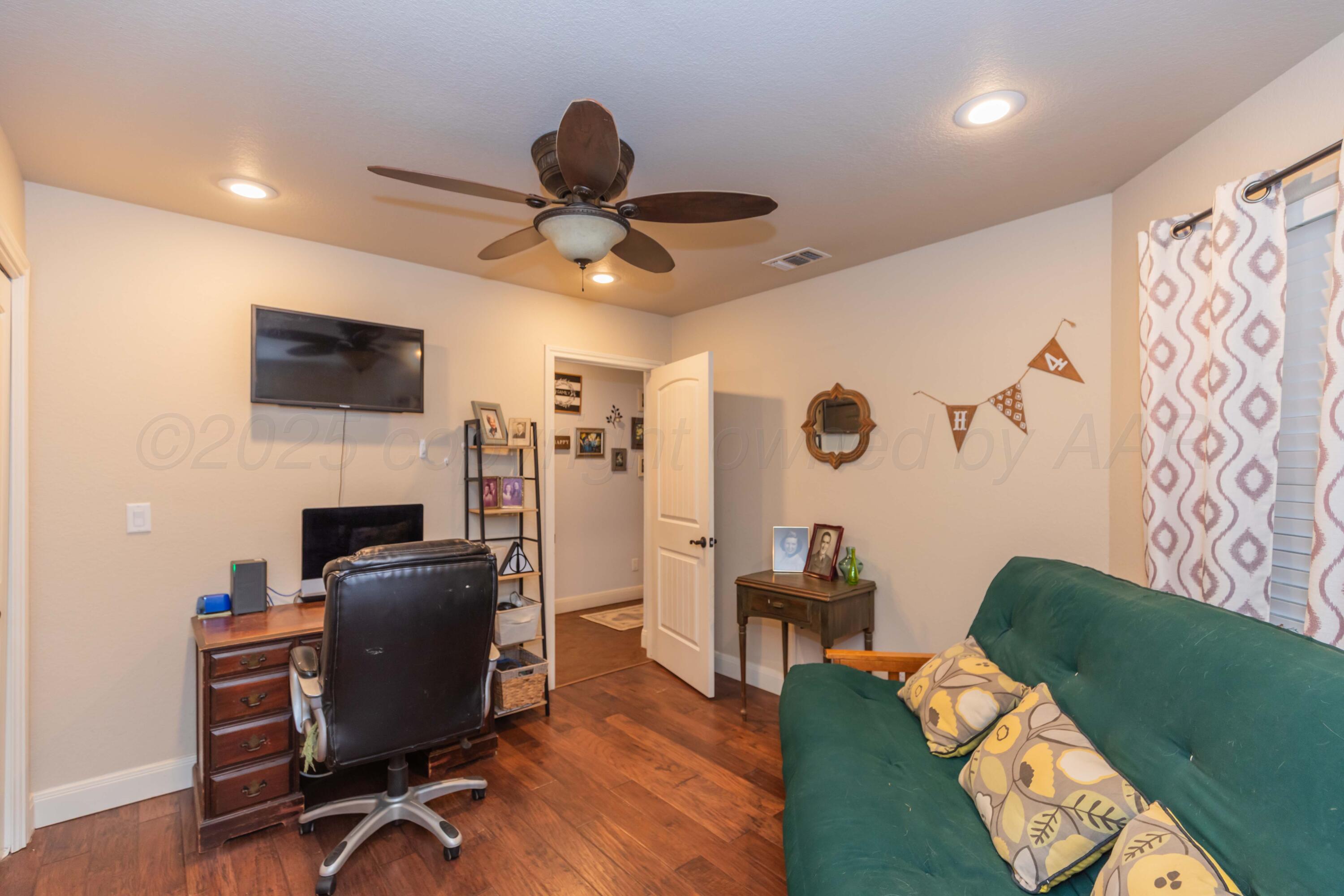 1301 Moon Ridge Lane Amarillo, TX 79124 - Photo 7 of 34 a view of a workspace with furniture and a flat screen tv