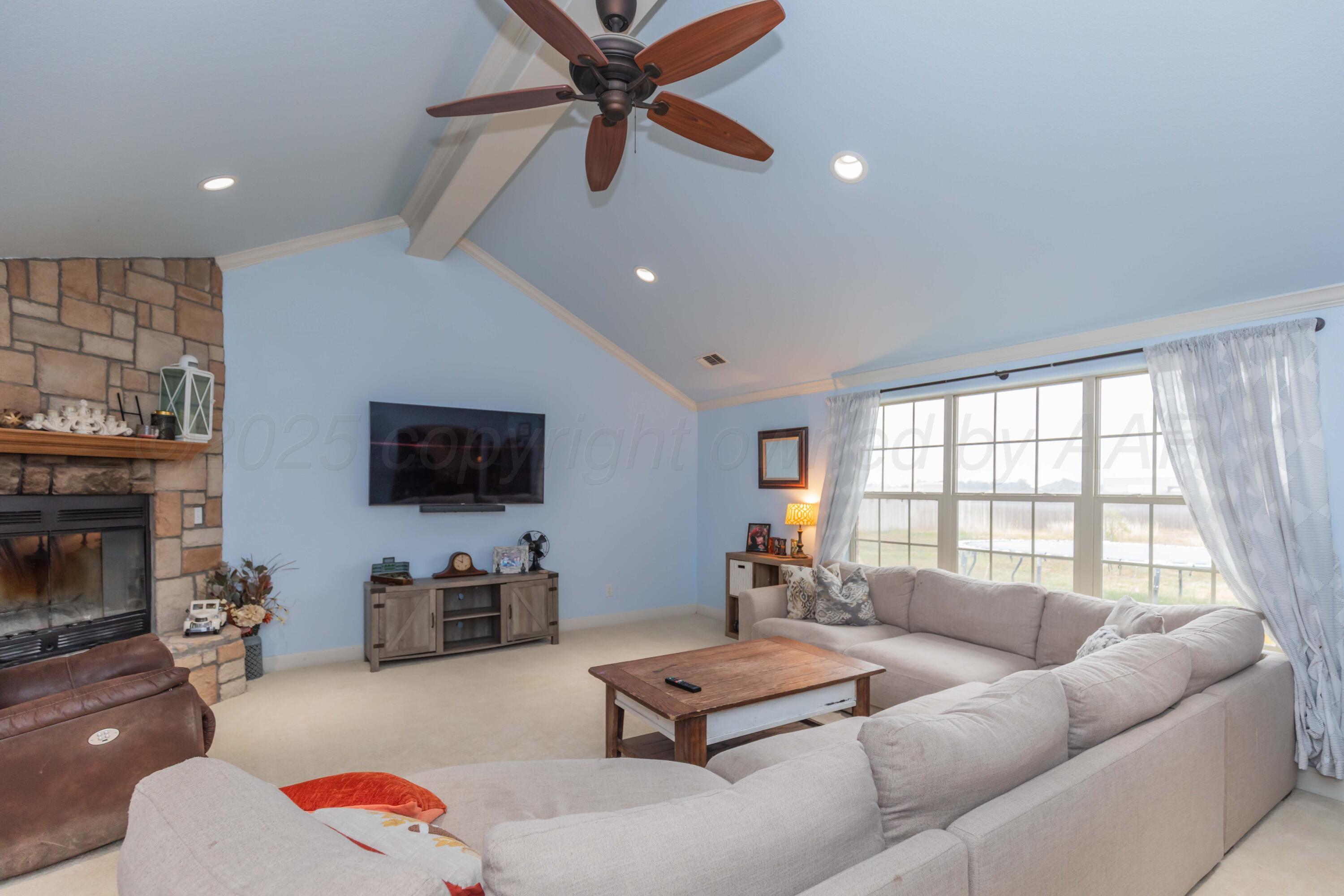 1301 Moon Ridge Lane Amarillo, TX 79124 - Photo 8 of 34 a living room with furniture flat screen tv and a fireplace
