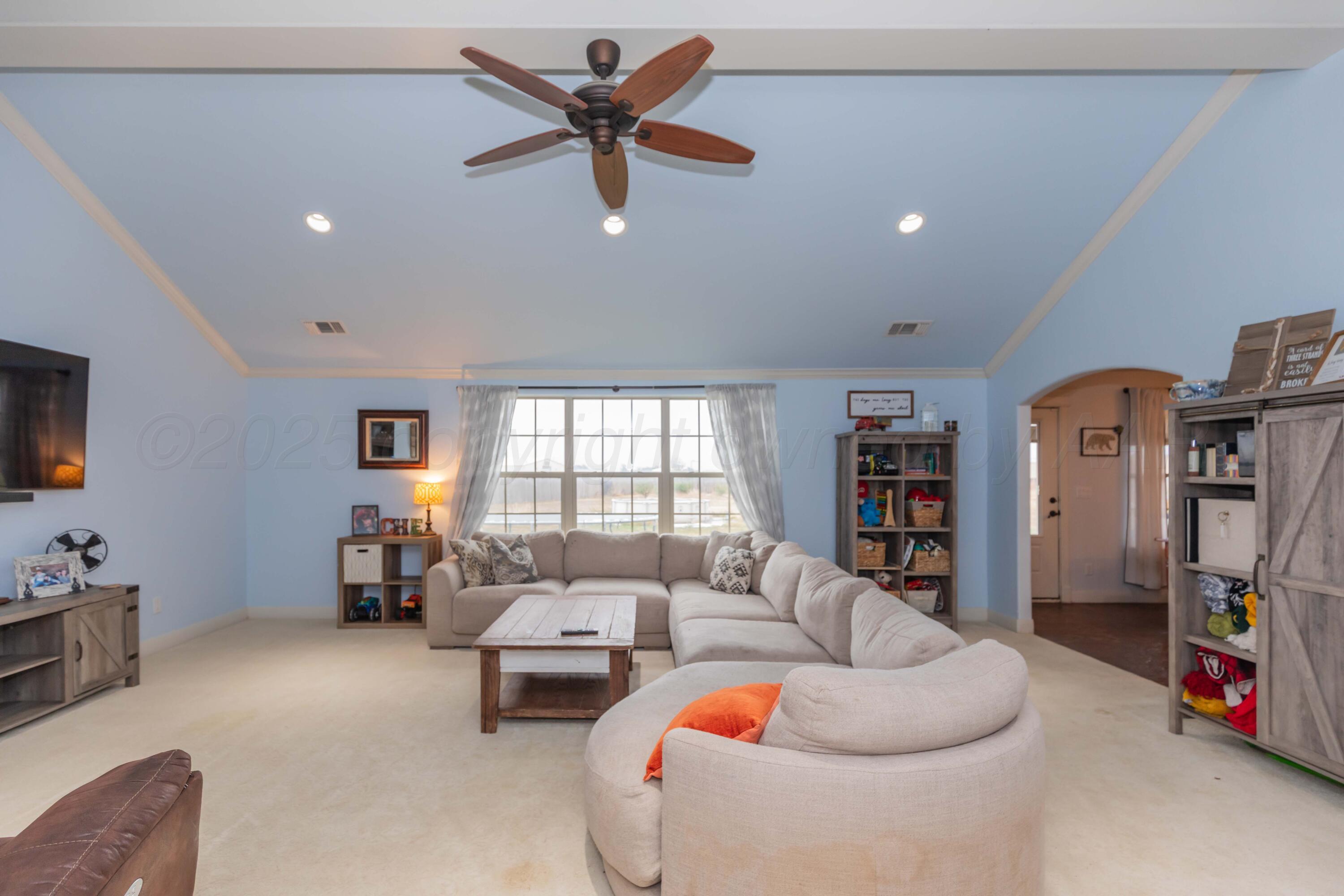 1301 Moon Ridge Lane Amarillo, TX 79124 - Photo 9 of 34 a living room with furniture and a flat screen tv
