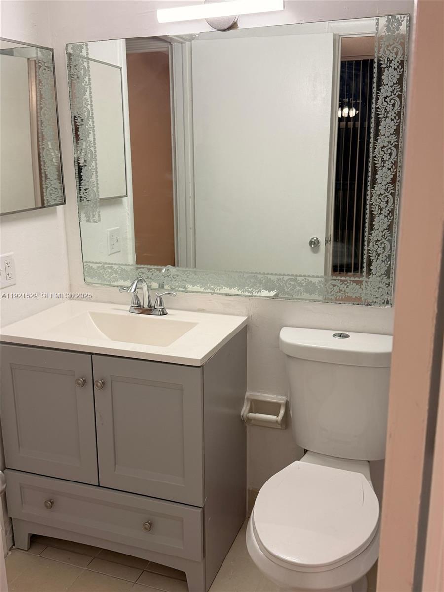 11800 Southwest 18th Street, Unit 4284 Miami, FL 33175 - Photo 9 of 14 a bathroom with a sink a toilet and mirror