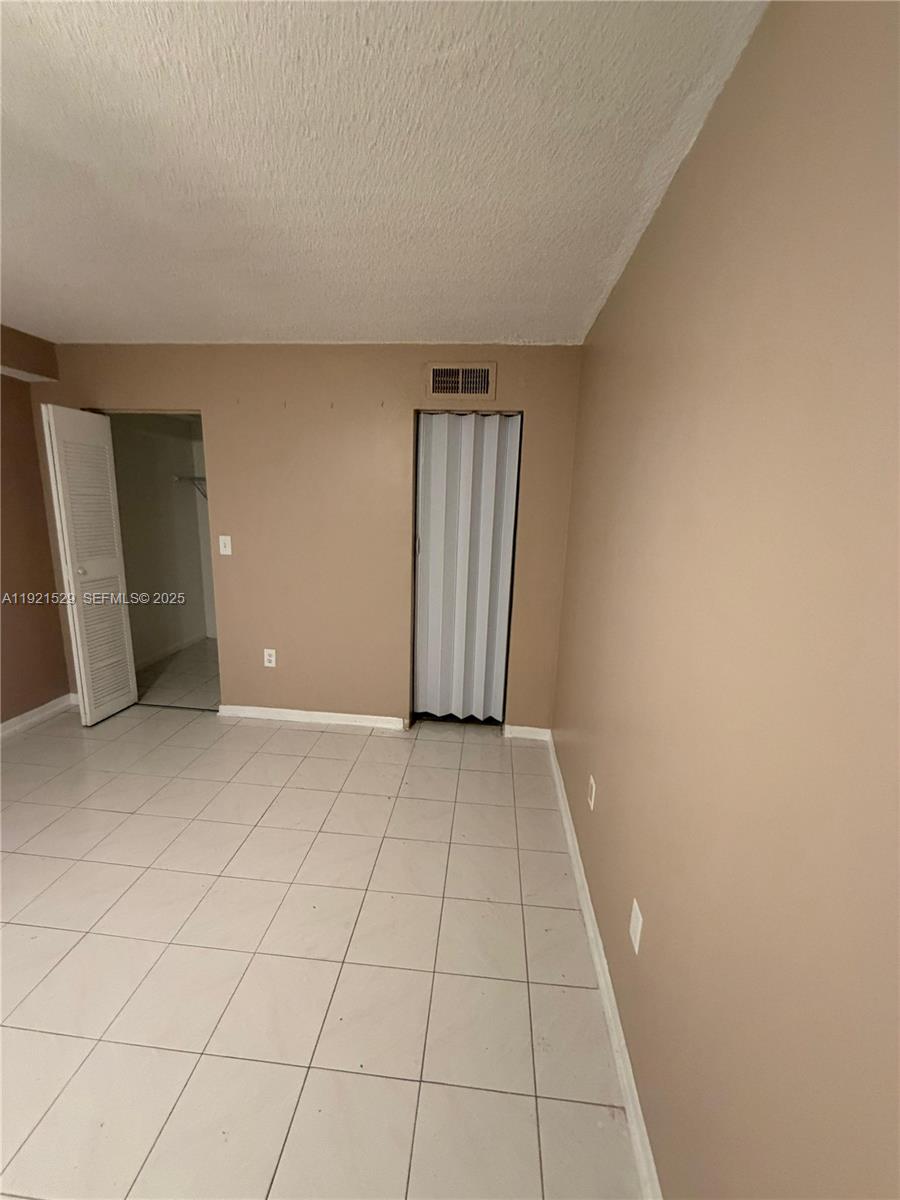 11800 Southwest 18th Street, Unit 4284 Miami, FL 33175 - Photo 10 of 14 an empty room with windows