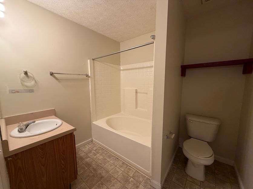 5196 Tew Lane Southwest Covington, GA 30014 - Photo 14 of 41 a bathroom with a toilet a sink and bathtub