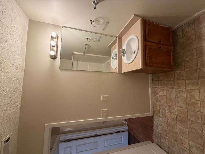 5196 Tew Lane Southwest Covington, GA 30014 - Photo 16 of 41 a bathroom with a sink and a mirror