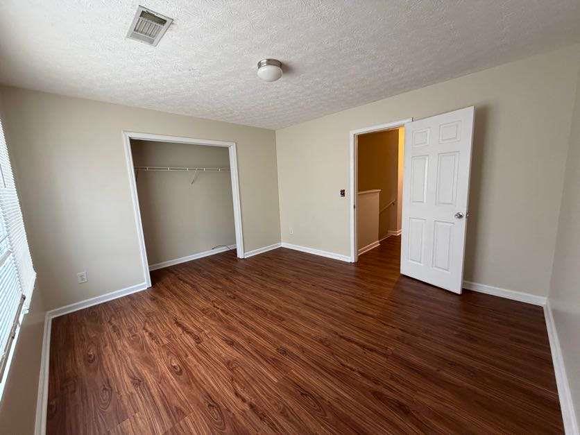5196 Tew Lane Southwest Covington, GA 30014 - Photo 22 of 41 an empty room with wooden floor and closet