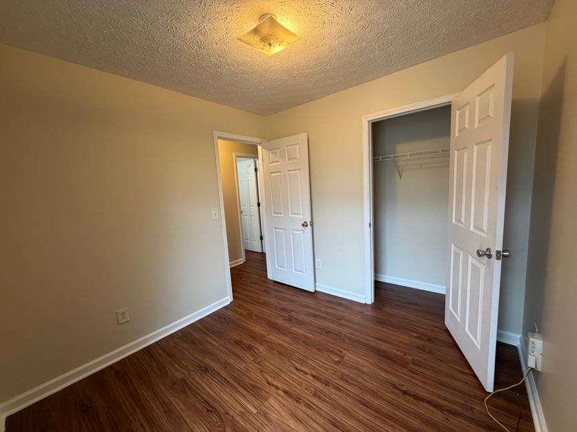 5196 Tew Lane Southwest Covington, GA 30014 - Photo 26 of 41 a view of an empty room with wooden floor and a window