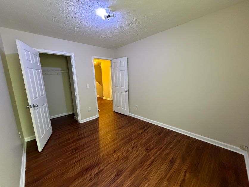 5196 Tew Lane Southwest Covington, GA 30014 - Photo 33 of 41 an empty room with wooden floor and closet