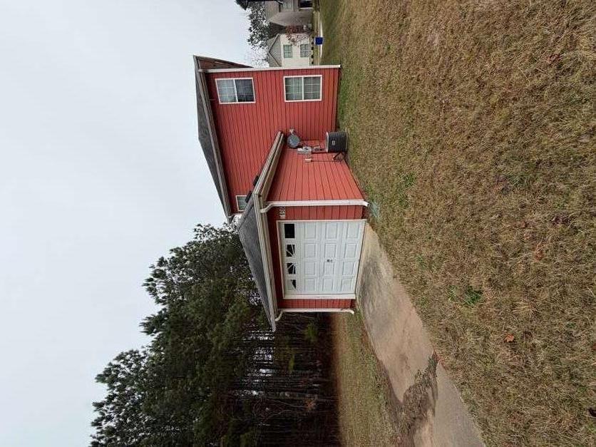 5196 Tew Lane Southwest Covington, GA 30014 - Photo 40 of 41 a front view of a house with a yard and garage