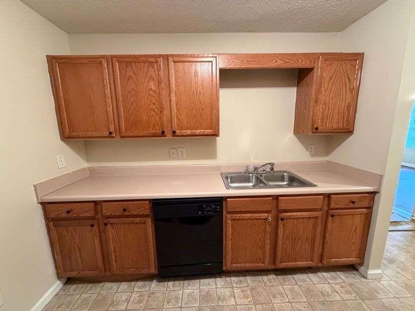 5196 Tew Lane Southwest Covington, GA 30014 - Photo 9 of 41 a kitchen with a sink and a cabinets