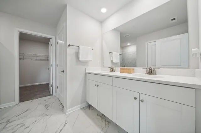 a bathroom with a double vanity sink mirror and shower