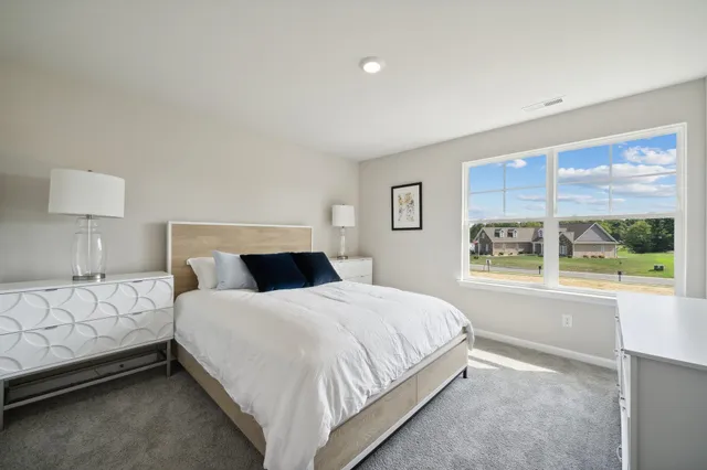 a bedroom with a large bed and a window