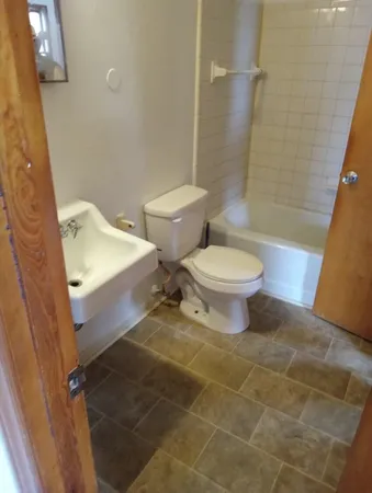 a bathroom with a toilet and a shower