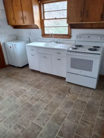 a kitchen with a stove a sink and a microwave