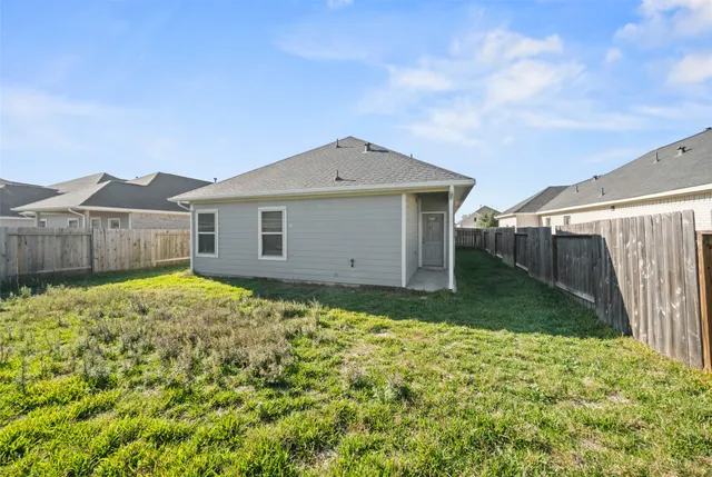 a backyard of a house with wooden fence