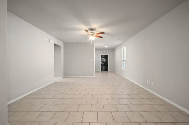 a view of an empty room with a ceiling fan