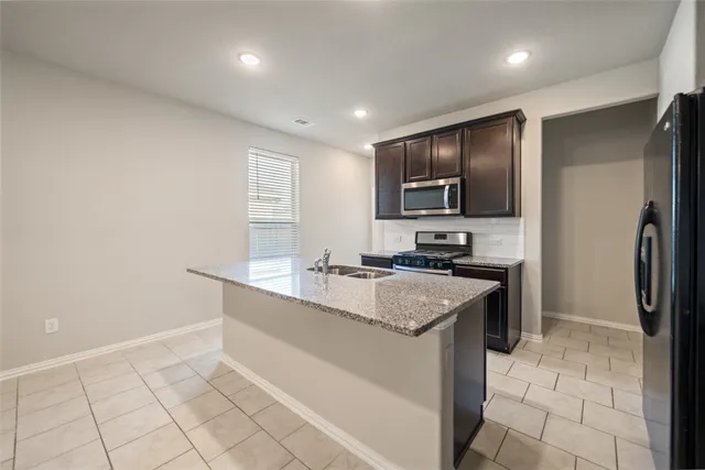a kitchen with sink cabinets and stainless steel appliances