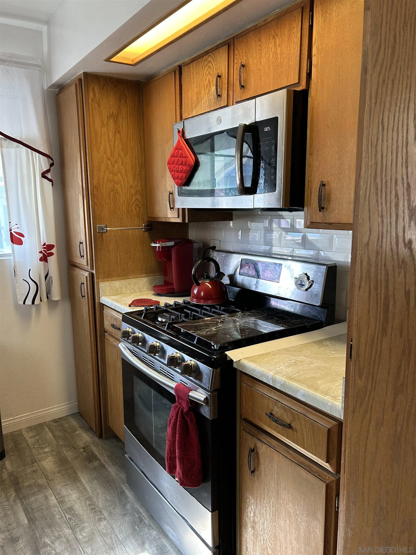 13300 Los Coches Road East, Unit 92 El Cajon, CA 92021 - Photo 3 of 21 a kitchen with a stove and a microwave