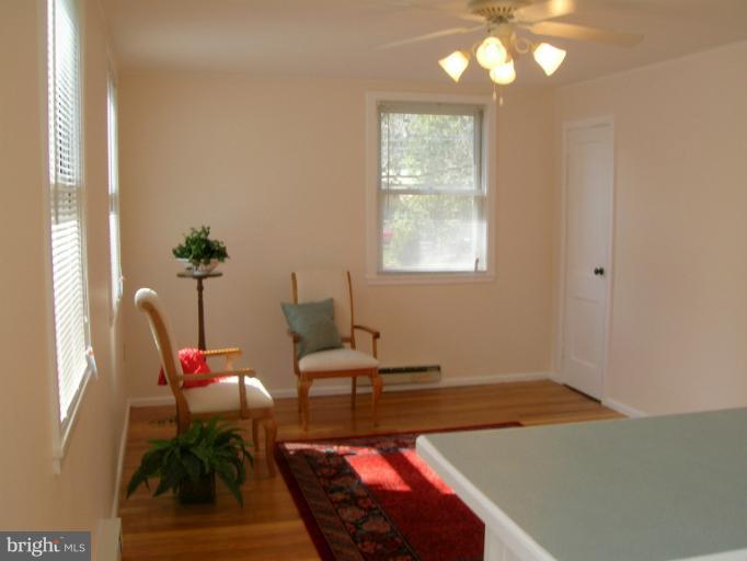 52 Ridge Road, Unit A Greenbelt, MD 20770 - Photo 1 of 22 a living room with furniture and a potted plant