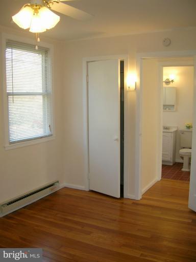 52 Ridge Road, Unit A Greenbelt, MD 20770 - Photo 11 of 22 a view of a room with wooden floor and a light fixture