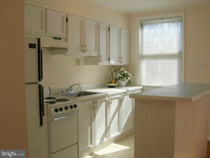 52 Ridge Road, Unit A Greenbelt, MD 20770 - Photo 13 of 22 a kitchen with stainless steel appliances granite countertop a sink a stove and a refrigerator