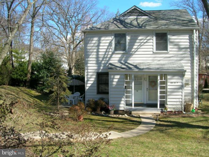 52 Ridge Road, Unit A Greenbelt, MD 20770 - Photo 17 of 22 a view of a house with a yard and lawn chairs