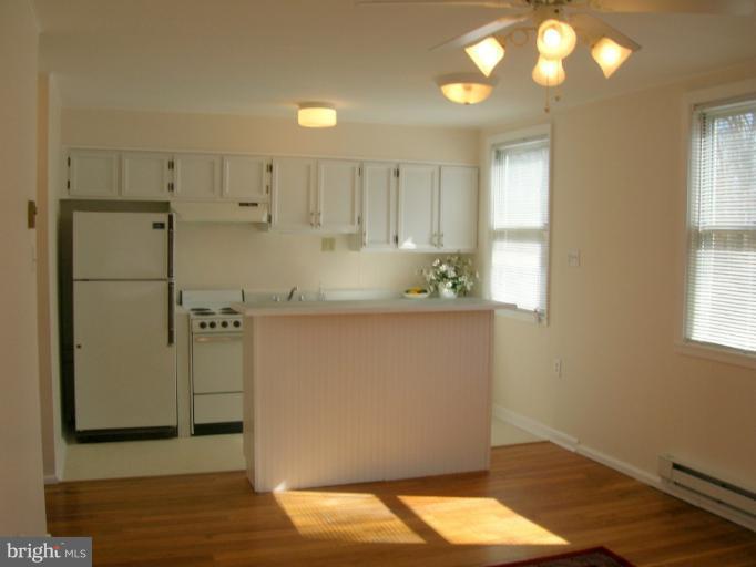 52 Ridge Road, Unit A Greenbelt, MD 20770 - Photo 20 of 22 a room with wooden floor and window