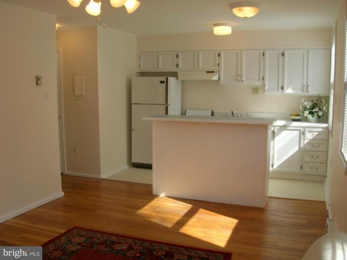 52 Ridge Road, Unit A Greenbelt, MD 20770 - Photo 3 of 22 a kitchen with kitchen island a sink appliances and cabinets